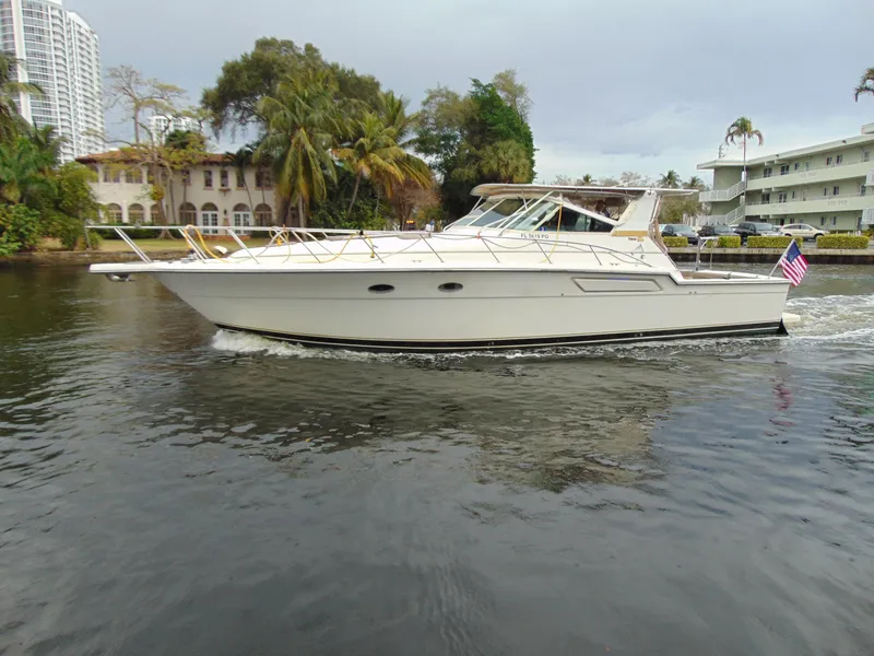 Slide: The Image of 1996 Tiara Yachts 4300 Open cruising on a waterway. - 0