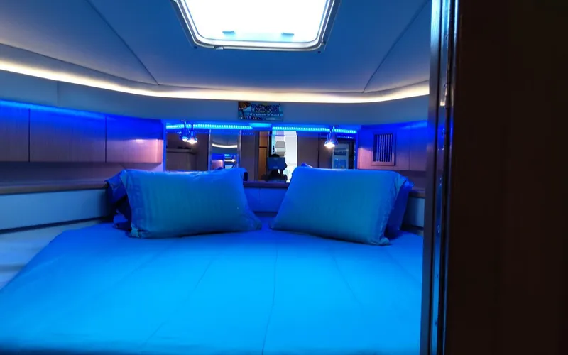 Slide: The Image of 1996 Tiara Yachts 4300 Open cabin with blue LED lighting and skylight. - 11