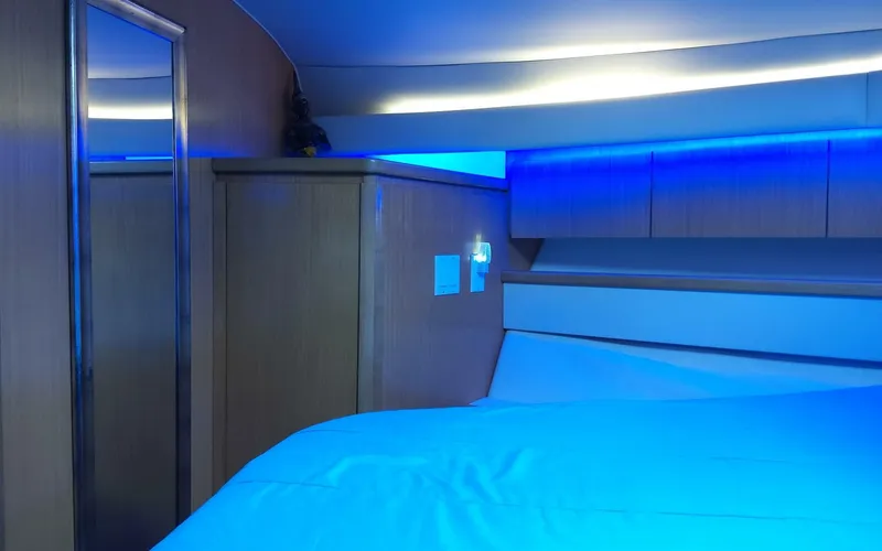 Slide: The Image of Interior cabin of 1996 Tiara Yachts 4300 Open with blue ambient lighting. - 12
