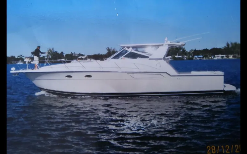 Slide: The Image of 1996 Tiara Yachts 4300 Open cruising on a calm waterway. - 4
