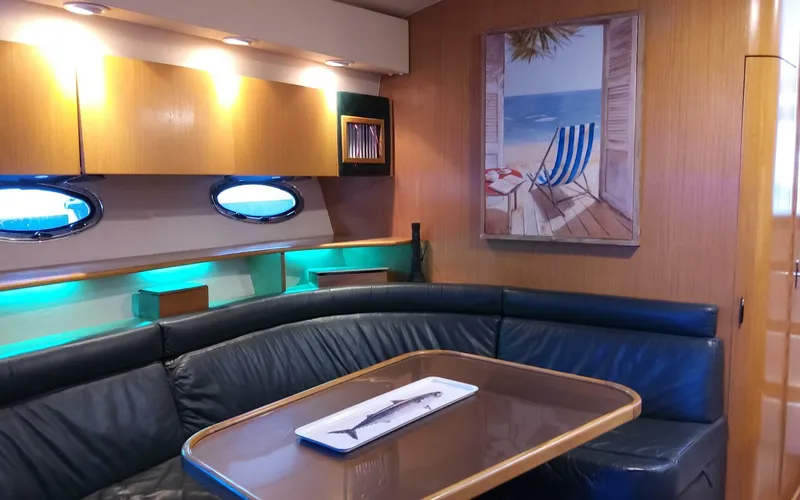Slide: The Image of Interior of a 1996 Tiara Yachts 4300 Open with a cozy dining area and beach-themed decor. - 5