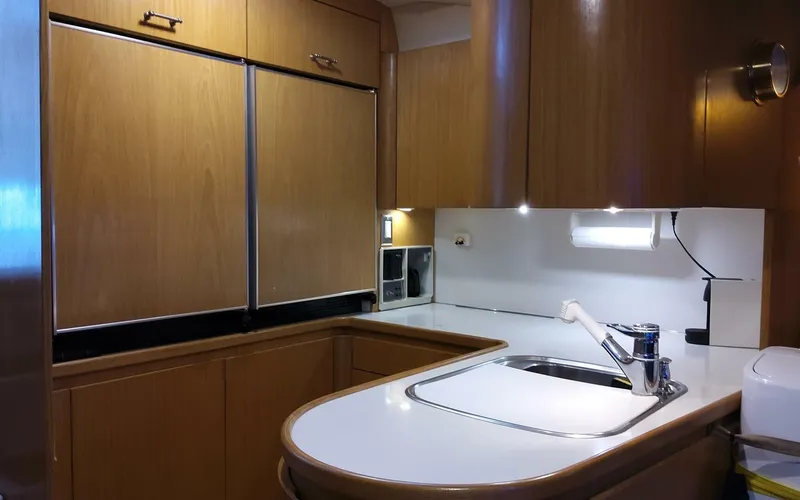 Slide: The Image of 1996 Tiara Yachts 4300 Open kitchen with wooden cabinets and modern appliances. - 8