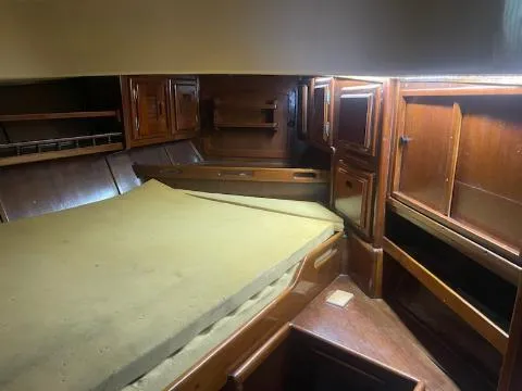 Slide: The Image of Interior cabin of 1981 Allied Mistress Mk III sailboat with wooden cabinetry and bed. - 10