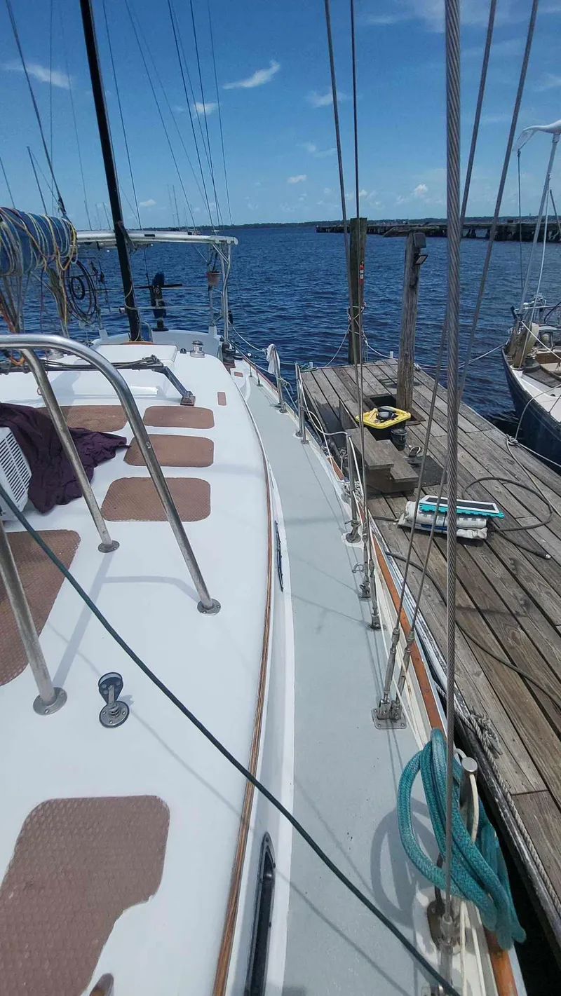 Slide: The Image of 1981 Allied Mistress Mk III sailboat docked at a marina on a sunny day. - 3