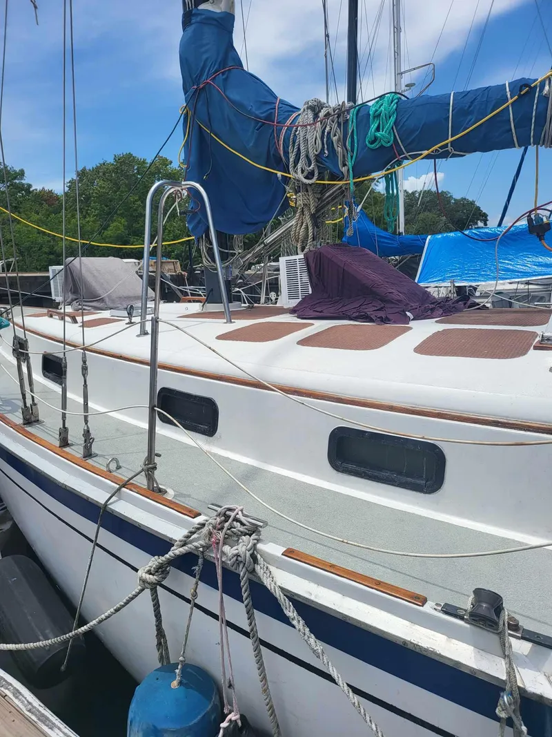 Slide: The Image of 1981 Allied Mistress Mk III sailboat docked with rigging and ropes. - 4
