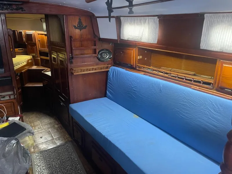 Slide: The Image of Interior of 1981 Allied Mistress Mk III sailboat with blue cushioned seating. - 6