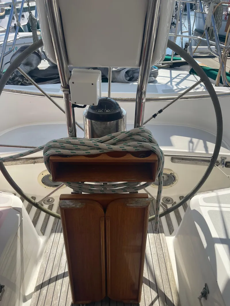 Slide: The Image of Cockpit of 1995 Passport 47 AC Plan B sailboat with steering wheel and navigation equipment. - 10