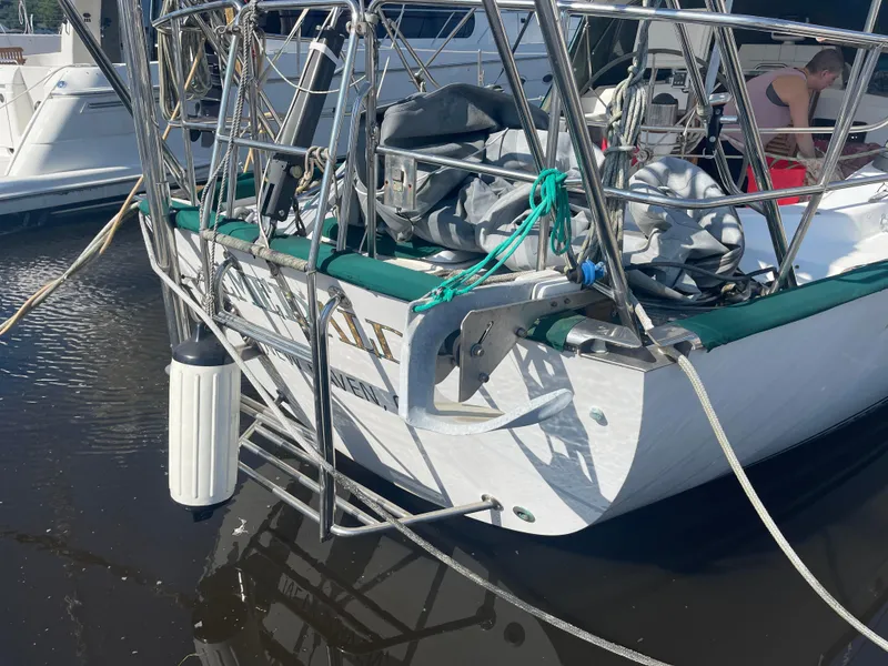 Slide: The Image of Sailboat docked, Passport 47 AC Plan B, 1995 model, with green trim and stainless steel railings. - 2