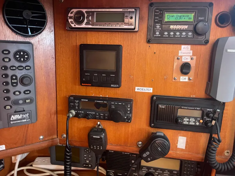 Slide: The Image of Control panel of a 1995 Passport 47 AC Plan B sailboat with various navigation and communication equipment. - 20
