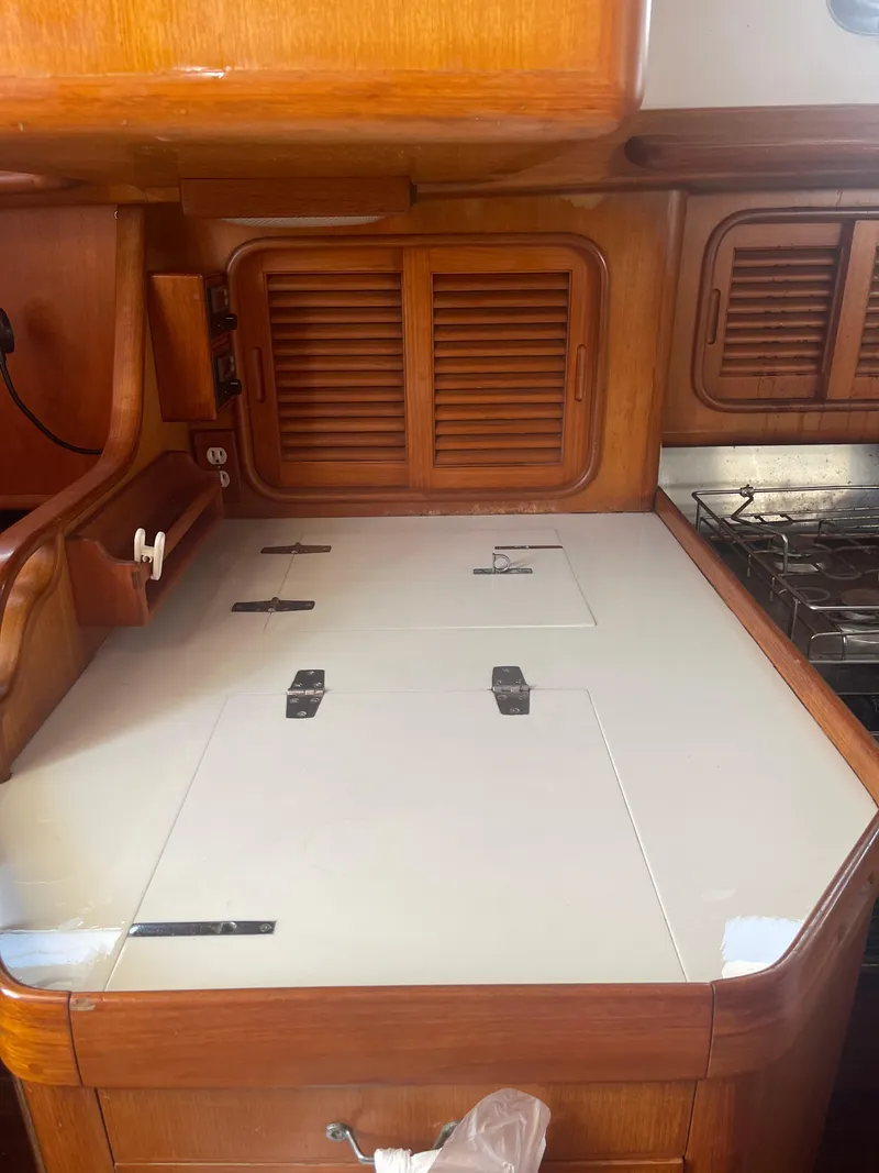 Slide: The Image of 1995 Passport 47 AC Plan B yacht kitchen with wooden cabinetry and stove. - 23