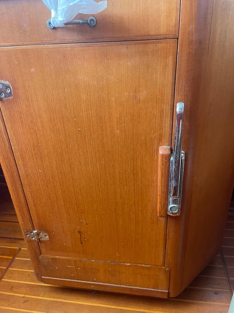 Slide: The Image of Wooden cabinet door on a 1995 Passport 47 AC Plan B sailboat. - 24