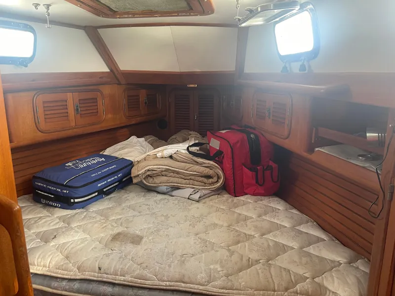 Slide: The Image of Cozy cabin interior of 1995 Passport 47 AC Plan B sailboat with bedding and storage. - 25