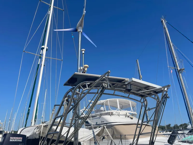 Slide: The Image of Sailboat Passport 47 AC Plan B 1995 docked with wind turbine and solar panels. - 4