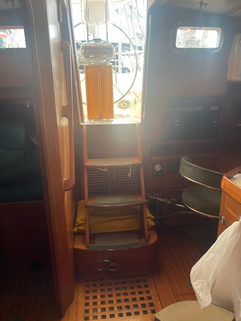 Slide: The Image of Interior of a 1995 Passport 47 AC Plan B sailboat with wooden finishes. - 40