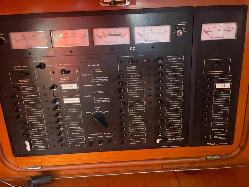 Slide: The Image of Control panel of a 1995 Passport 47 AC Plan B yacht with AC and DC switches. - 41
