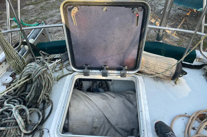Slide: The Image of Open hatch on 1995 Passport 47 AC Plan B sailboat deck with ropes and equipment. - 44