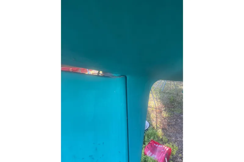 Slide: The Image of Close-up of a teal structure, possibly a boat hull, with red objects nearby. - 51