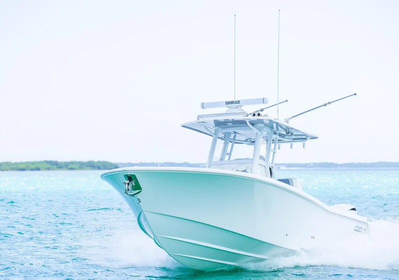 Slide: The Image of 2024 Invincible 33 Open Fisherman boat cruising on clear blue water. - 16