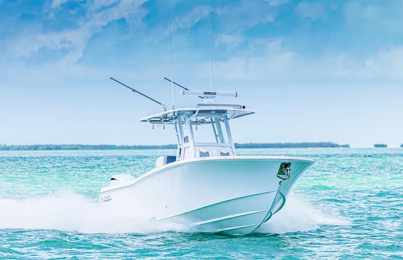 Slide: The Image of 2024 Invincible 33 Open Fisherman boat cruising on turquoise waters. - 2