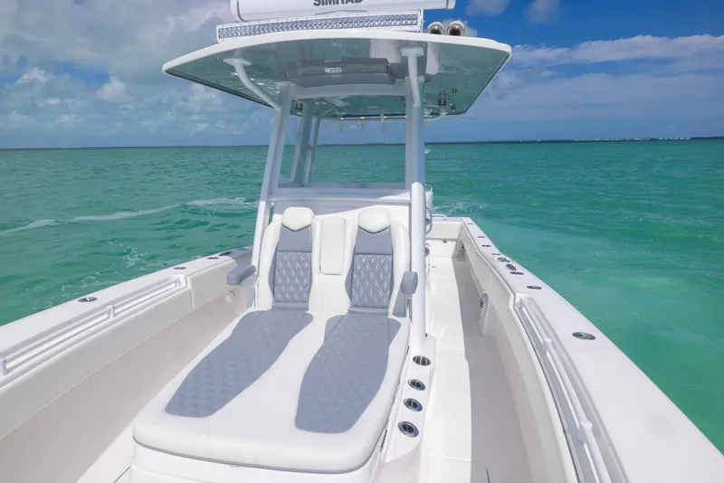 Slide: The Image of 2024 Invincible 33 Open Fisherman boat on turquoise water. - 32