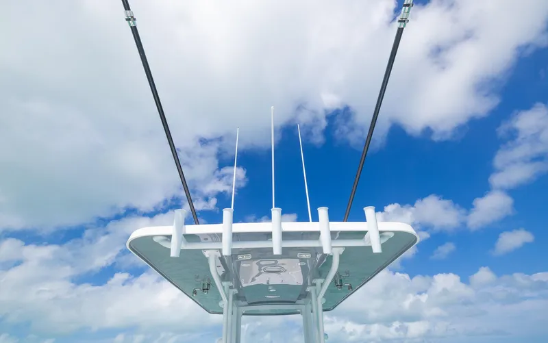 Slide: The Image of 2024 Invincible 33 Open Fisherman boat against blue sky and clouds. - 41