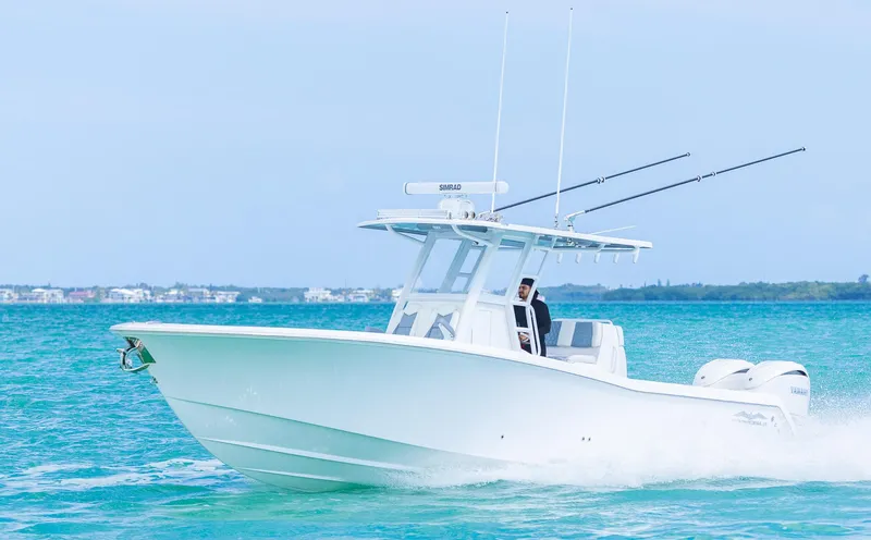 Slide: The Image of 2024 Invincible 33 Open Fisherman boat cruising on clear blue water. - 6