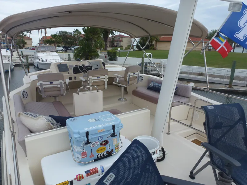 Slide: The Image of 2005 Mainship 34 Trawler boat with spacious deck and seating area. - 11