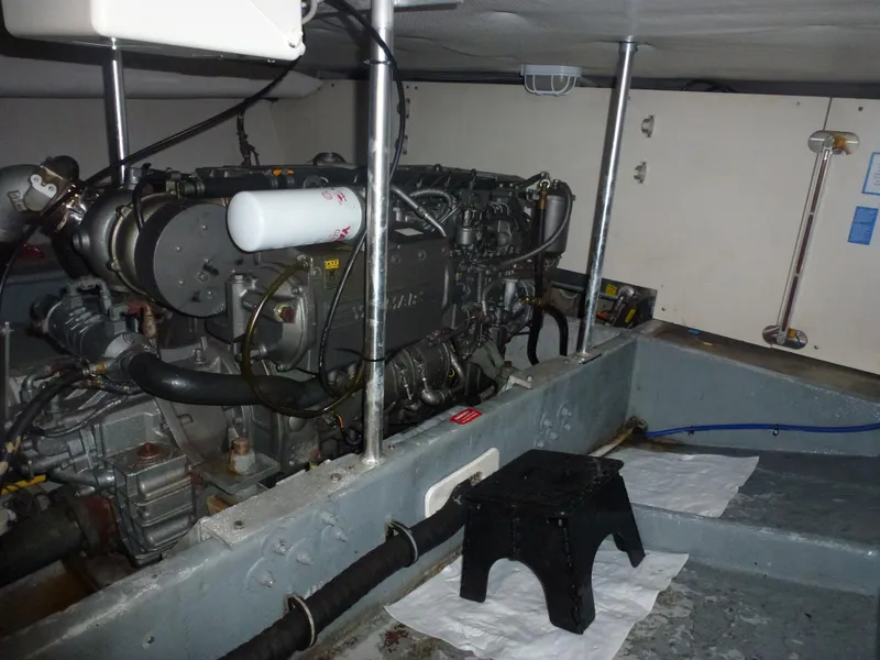 Slide: The Image of Engine room of a 2005 Mainship 34 Trawler with visible engine components. - 12