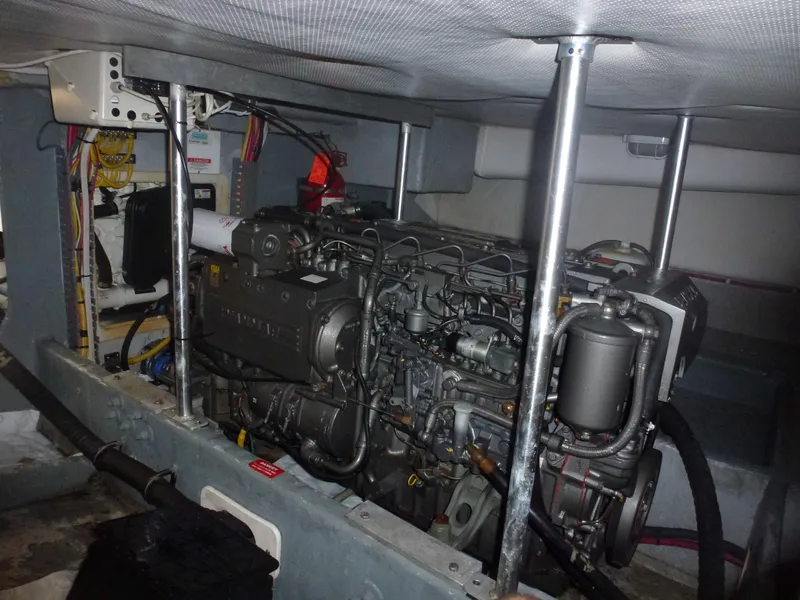 Slide: The Image of Engine room of a 2005 Mainship 34 Trawler with visible engine components. - 13