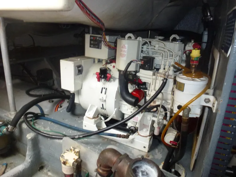 Slide: The Image of Engine compartment of a 2005 Mainship 34 Trawler with visible wiring and components. - 14