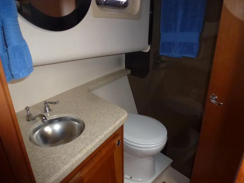 Slide: The Image of 2005 Mainship 34 Trawler bathroom with sink, toilet, and mirror. - 22