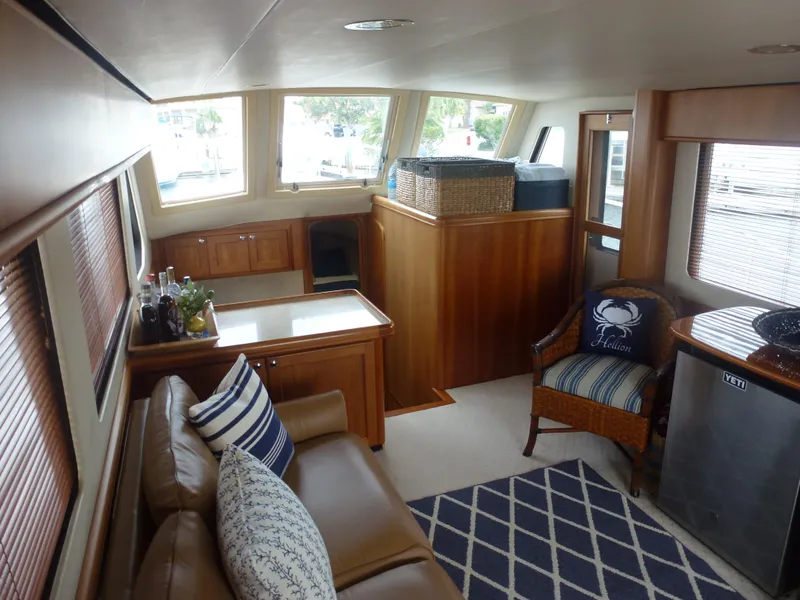 Slide: The Image of Interior of 2005 Mainship 34 Trawler with cozy seating and nautical decor. - 27