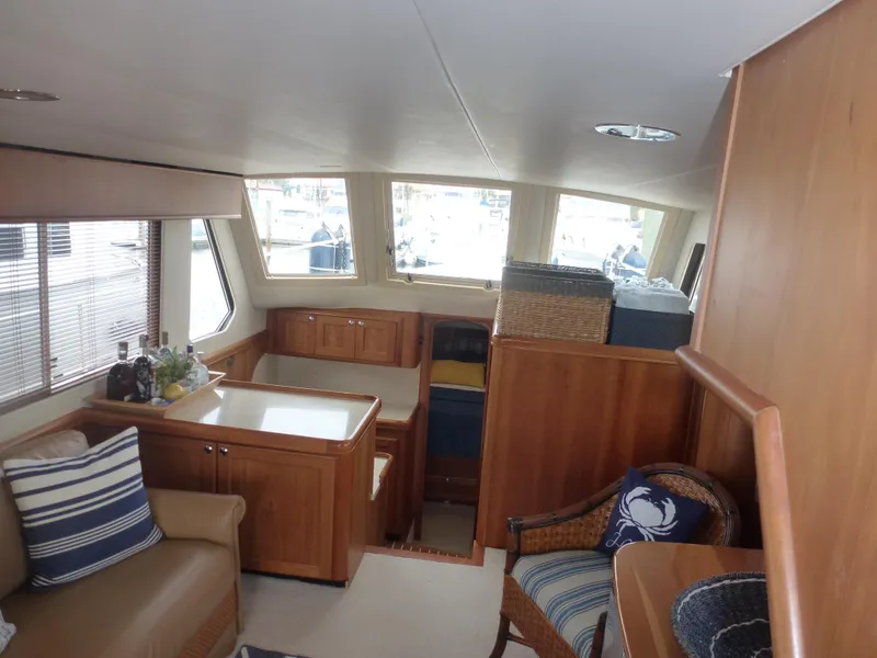 Slide: The Image of Interior of a 2005 Mainship 34 Trawler with wooden furnishings and seating area. - 28