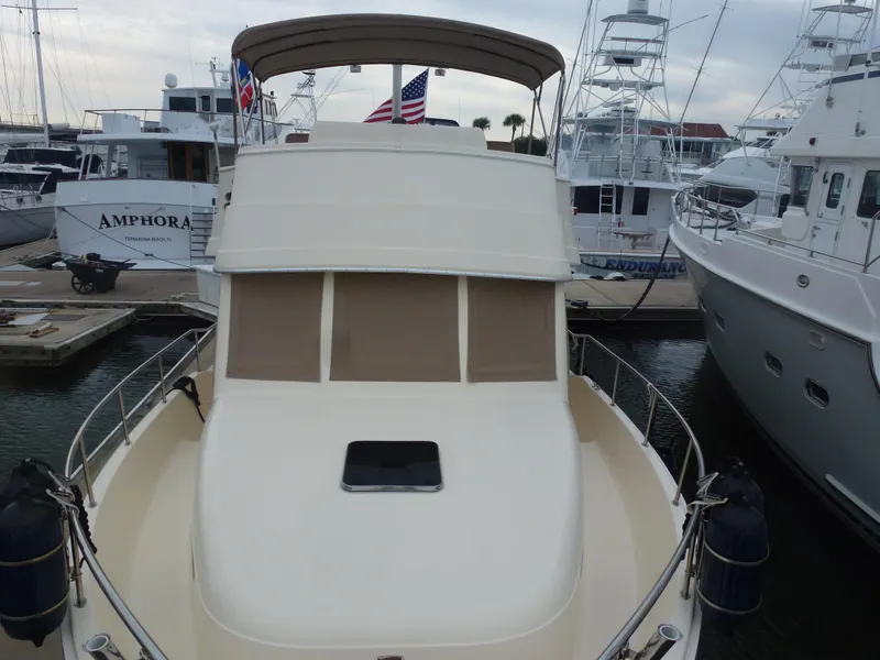 Slide: The Image of 2005 Mainship 34 Trawler docked at marina with other boats. - 4