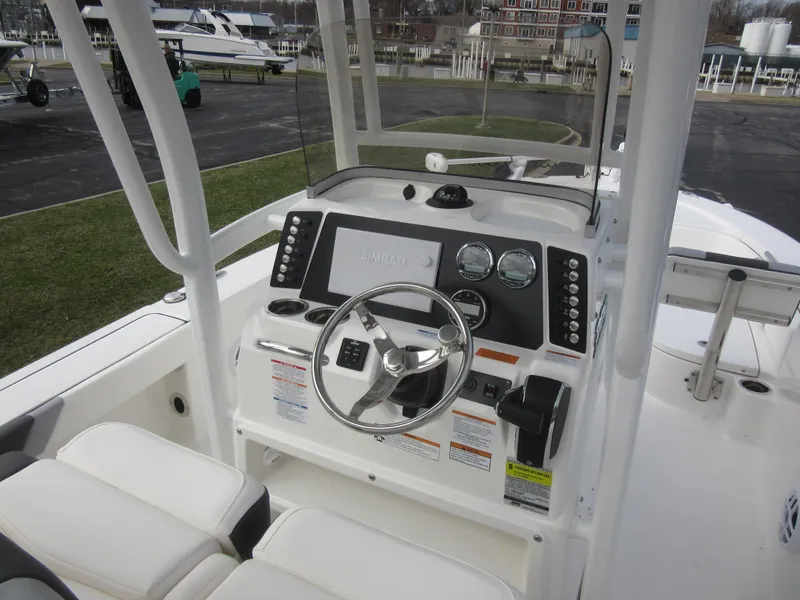 Slide: The Image of 2024 Robalo 226 Cayman boat console with steering wheel and control panel. - 10