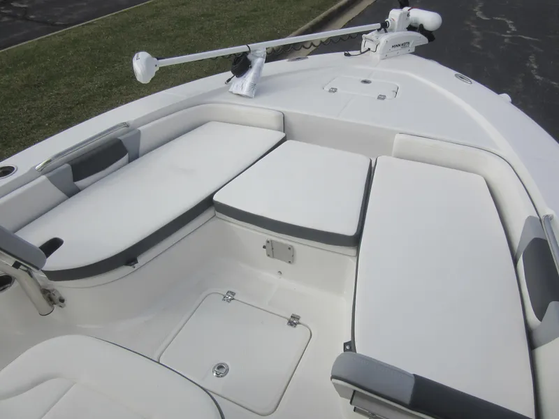 Slide: The Image of 2024 Robalo 226 Cayman boat with cushioned seating and storage compartments. - 14