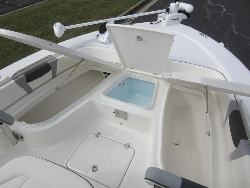 Slide: The Image of 2024 Robalo 226 Cayman boat interior with storage compartments and livewell. - 16