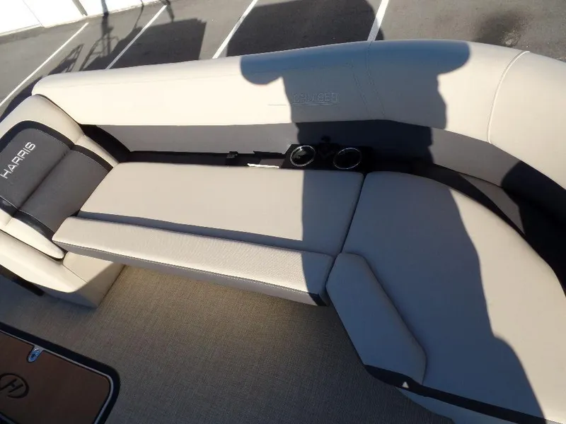 Slide: The Image of 2024 Harris Cruiser 250 boat seating with cup holders, beige upholstery. - 10