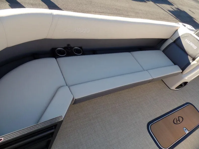Slide: The Image of 2024 Harris Cruiser 250 boat interior with cushioned seating and cup holders. - 11