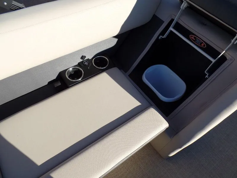 Slide: The Image of 2024 Harris Cruiser 250 interior with cup holders and storage compartment. - 12