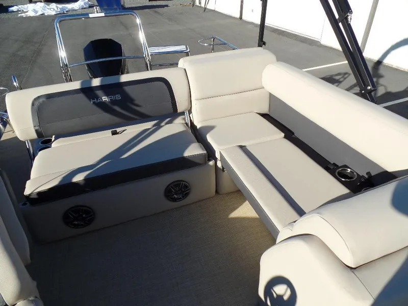 Slide: The Image of 2024 Harris Cruiser 250 boat interior with beige seating and built-in speakers. - 13