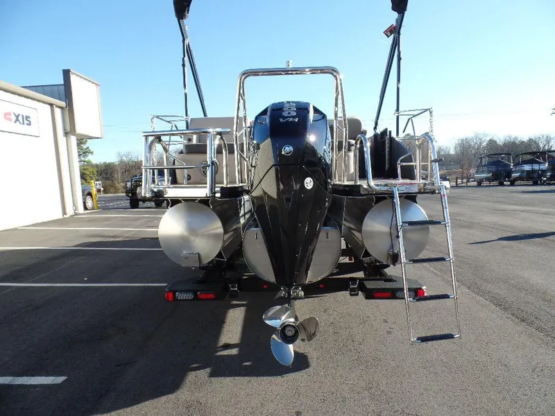 Slide: The Image of 2024 Harris Cruiser 250 pontoon boat rear view with ladder and motor. - 15