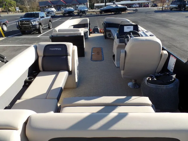 Slide: The Image of 2024 Harris Cruiser 250 pontoon boat interior with spacious seating and modern helm. - 2