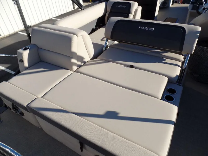 Slide: The Image of 2024 Harris Cruiser 250 boat interior with beige seating and cup holders. - 3