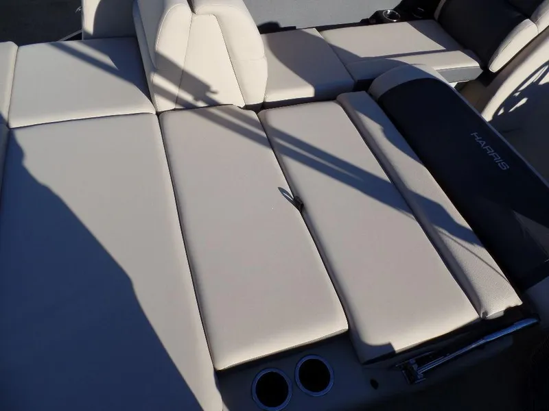 Slide: The Image of 2024 Harris Cruiser 250 boat interior with beige seating and cup holders. - 4
