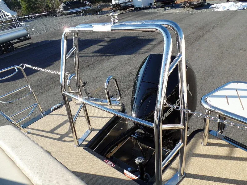 Slide: The Image of 2024 Harris Cruiser 250 boat with sleek chrome railing and powerful Mercury engine. - 6