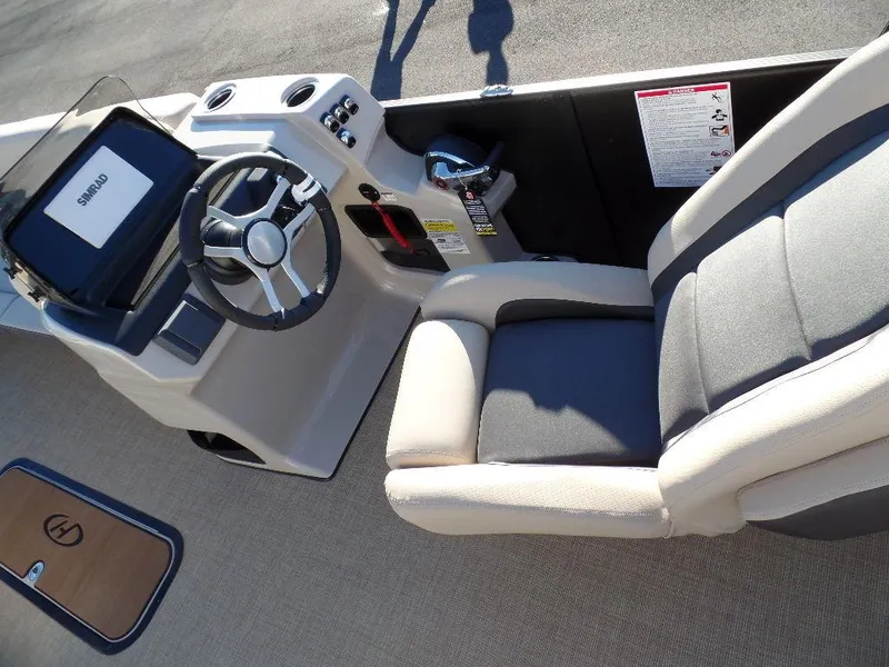 Slide: The Image of 2024 Harris Cruiser 250 boat interior with steering wheel and seating. - 8