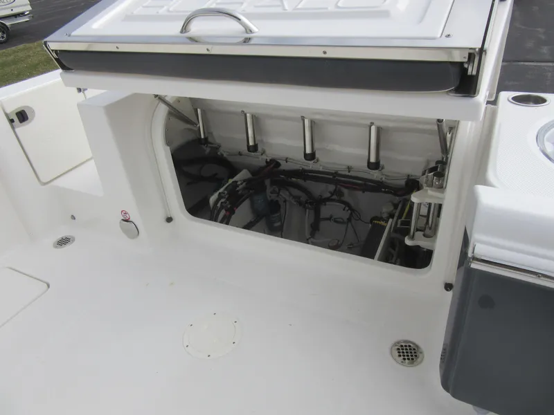 Slide: The Image of 2024 Robalo R250 Center Console boat storage compartment and engine access. - 10