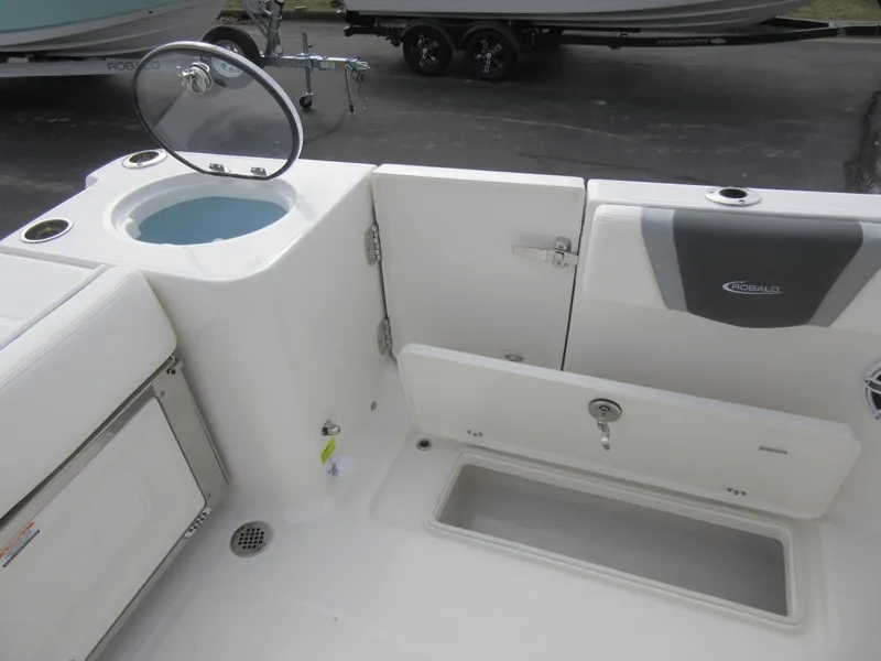 Slide: The Image of 2024 Robalo R250 Center Console boat interior with storage compartments and livewell. - 11