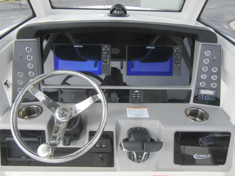 Slide: The Image of 2024 Robalo R250 Center Console boat dashboard with dual Simrad displays. - 13